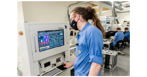 Operator using AOI system to inspect PCB assembly in production line