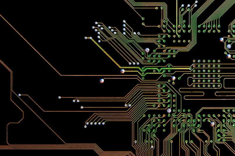 Close-up of fine-pitch traces and vias on FR-4 microstrip/stripline routing for high-speed signals.
