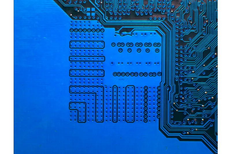 Blue solder-mask PCB with dense via arrays and fine traces for QFN/BGA footprint—DFM considerations in PCB assembly design.