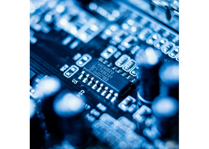 SOIC microchip and passives on a PCBA; example of decoupling placement and clean land patterns per IPC-7351.