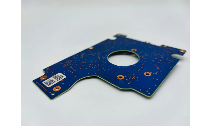 Bare PCB with solder mask and vias—fabrication data prior to assembly. Fabrication data defines geometry; assembly adds BOM and XY/θ.